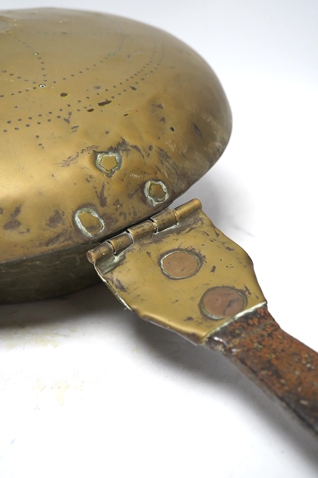 A 17th century brass and iron warming pan, 112cm. Condition - poor